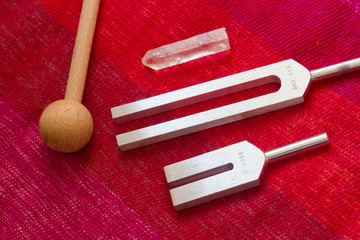 tuning fork and crystal on table .
