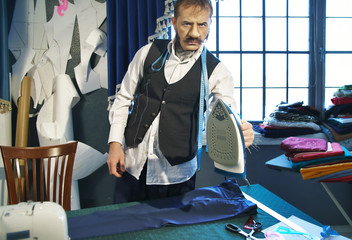 Tailor irons a trousers