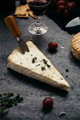 Vertical View of Brie Garnished with Thyme on Rustic Table