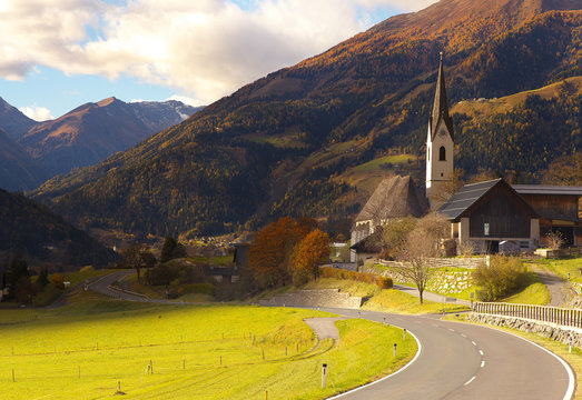View of a road and St Maria church in Obervellach village, Austria