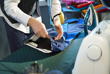 Tailor irons a trousers