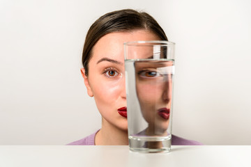 Woman Face Distortion In Glass Of Water