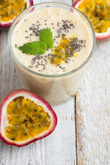 Smoothies passion fruit, milk and chia seeds closeup on white background
