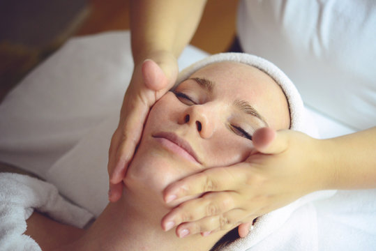 Close-up of a young woman getting Spa treatment at beauty salon - Spa Face Massage