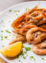 Close up appetizer. Shrimps on plate with lemon.