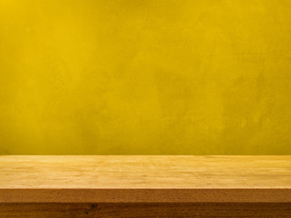 Empty wooden table on orange yellow wall