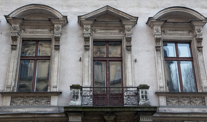 Fototapeta na wymiar Glass window in the facade of an old house