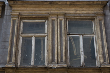 Glass wooden window in the facade of an old house