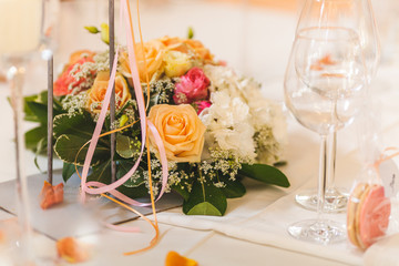 The elegant dinner table with flowers and cards