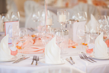 The elegant dinner table with flowers and cards