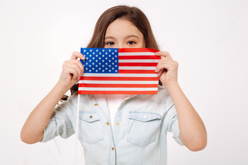 Pleasant girl holding American symbolic in the studio