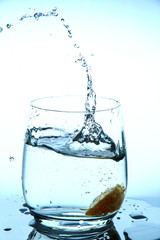 water splash in glass from falling slices of mandarin