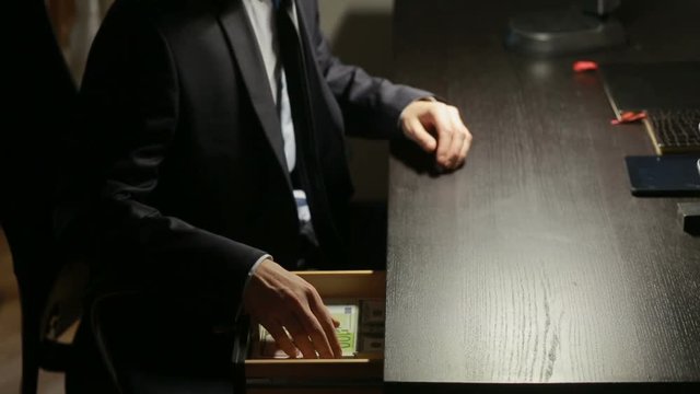 corruption, bribery and fraud concept - close up of businessman taking money