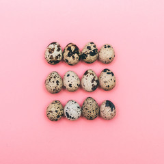 Easter quail eggs on a pink background. Fashion minimal, flat lay.