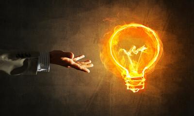 Concept of electricity or inspiration with burning light bulb