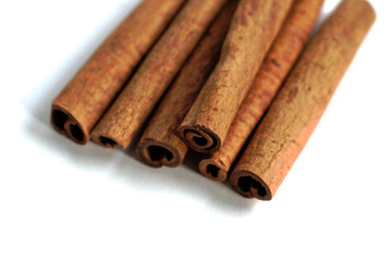 Closeup of cinnamon sticks on a white background