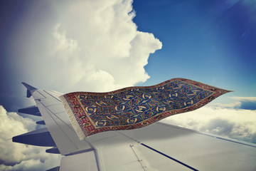 surrealistic flying carpet over an airplane in the blue sky. Partial 3D rendering