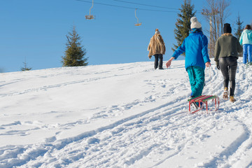 group of young friends having fun in the snow