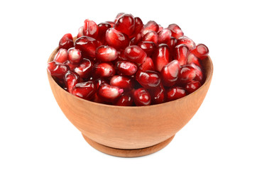 Pomegranate seeds in a wooden bowl