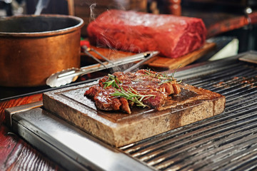 The grilled beef steak on a wooden board.