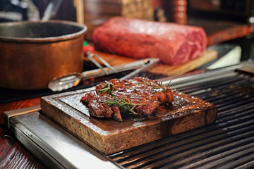 The grilled beef steak on a wooden board.