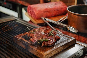 The grilled beef steak on a wooden board.