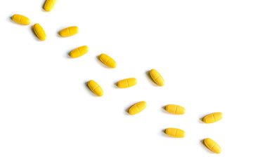 The path of yellow tablets on a white background. Isolated with shadows
