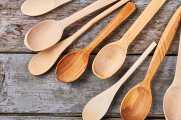 Different wooden spoons on retro background.