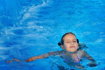 Real toddler girl at swimming pool