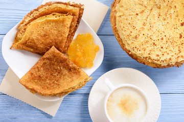 Pancakes with jam and cup of coffee.