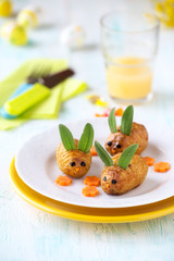 Easter bunnies for children made of baked potatoes and sage leaves. Fun food for kids