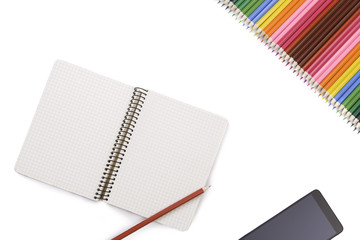 Creative workspace desk with notebook, smartphone and pencils isolated on white background