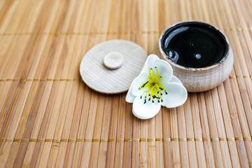 black substance in wooden jar on a wooden background. Black Mask 