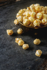 Obraz na płótnie Canvas Sweet popcorn in a bowl. Gray background. Watch a movie.
