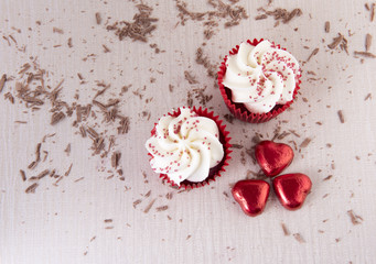 Fototapeta na wymiar Two red velvet cupcakes with chocolate sprinkles. 