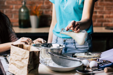 Obraz na płótnie Canvas Woman pouring milk into the bowl