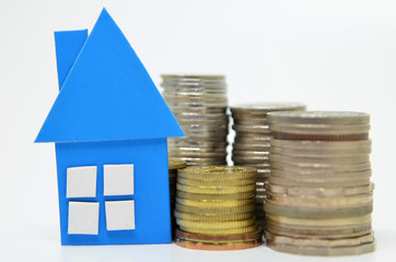 House model and stacks of coins