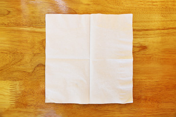 one piece of tissue on wooden table