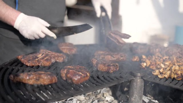 People cook barbecue grill, grilled steak, Frying fresh meat, Chicken BBQ, sausage, kebabs, hamburger, picnic with mushrooms and meat