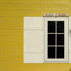 Obraz na płótnie Canvas white window on wooden yellow wall