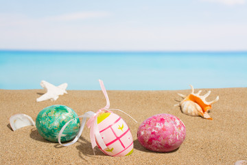 Fototapeta na wymiar Easter on beach background. Eggs on the