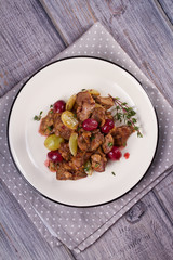 Liver with red and white grape garnished with thyme. View from above, top studio shot