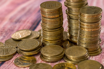 Stack of coins on wooden table  .