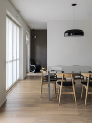 interior view of a modern living room with dining table and wooden floor