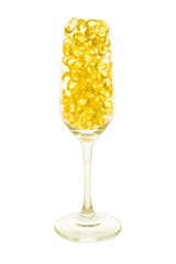 Fish oil soft capsule in champagne glass with clipping path isolated on white background.
