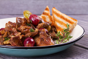 Liver with red and white grape garnished with thyme