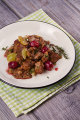 Liver with red and white grape garnished with thyme