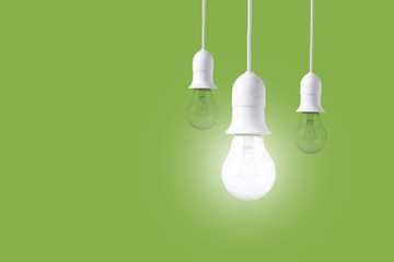 difference light bulb on green background. concept of new ideas with innovation and creativity.