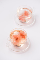 Cherry blossom (sakura) Japanese Herb tea on white background.