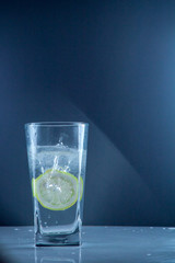 slice of lemon drops in a glass of water